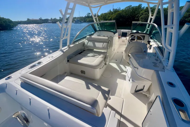 Slide: The Image of 2018 Boston Whaler 230 Vantage boat interior with seating and helm, on a sunny day. - 9