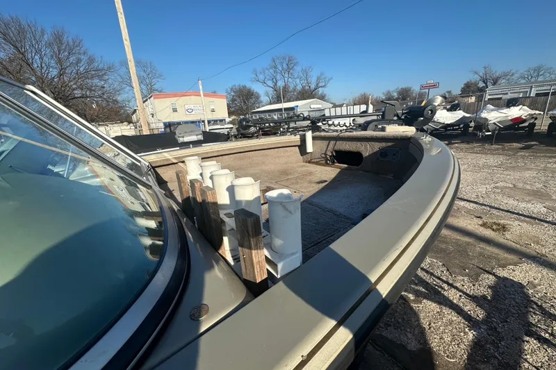 Slide: The Image of 2006 Lowe Fish & Ski 175 boat in outdoor storage, showcasing deck and rod holders. - 12