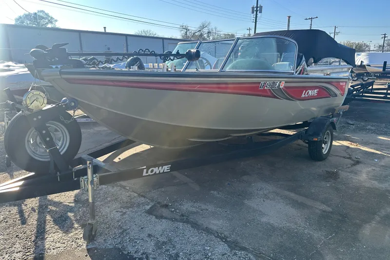 Slide: The Image of 2006 Lowe Fish & Ski 175 boat on trailer, parked outdoors in sunlight. - 2