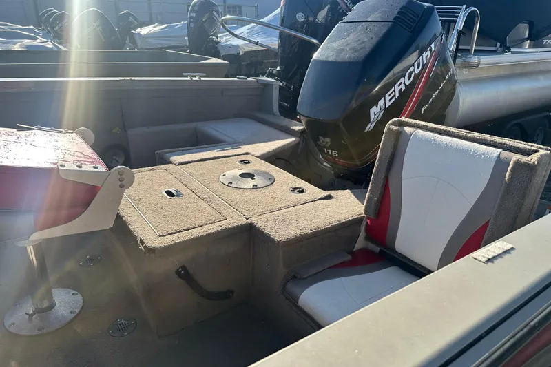 Slide: The Image of 2006 Lowe Fish & Ski 175 boat interior with Mercury 115 engine, featuring seating and storage. - 5