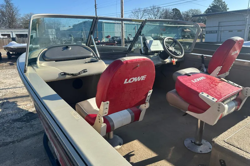 Slide: The Image of 2006 Lowe Fish & Ski 175 boat interior with red seats and steering console. - 6