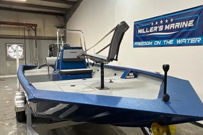Slide: The Image of 2025 SeaArk Shadow 187T boat in showroom, blue exterior, Miller's Marine banner. - 2