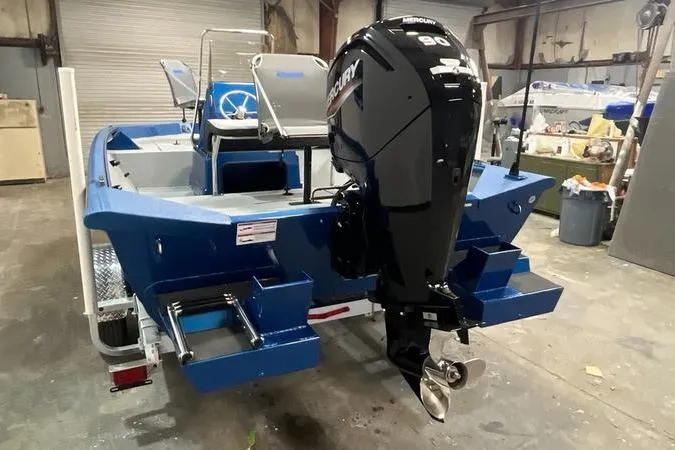 Slide: The Image of 2025 SeaArk Shadow 187T boat with Mercury outboard motor in a workshop setting. - 4