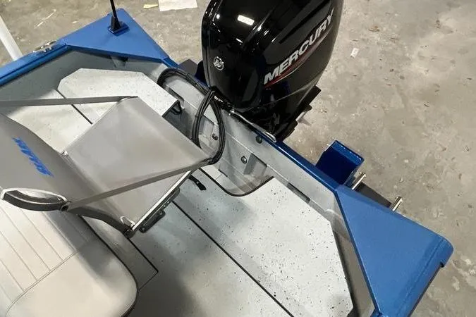 Slide: The Image of 2025 SeaArk Shadow 187T boat with Mercury outboard motor, featuring blue and gray interior. - 5