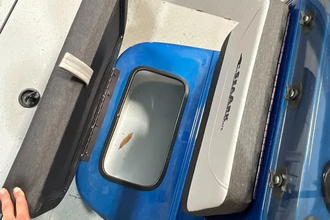 Slide: The Image of 2025 SeaArk Shadow 187T boat storage compartment with open lid and visible interior. - 9