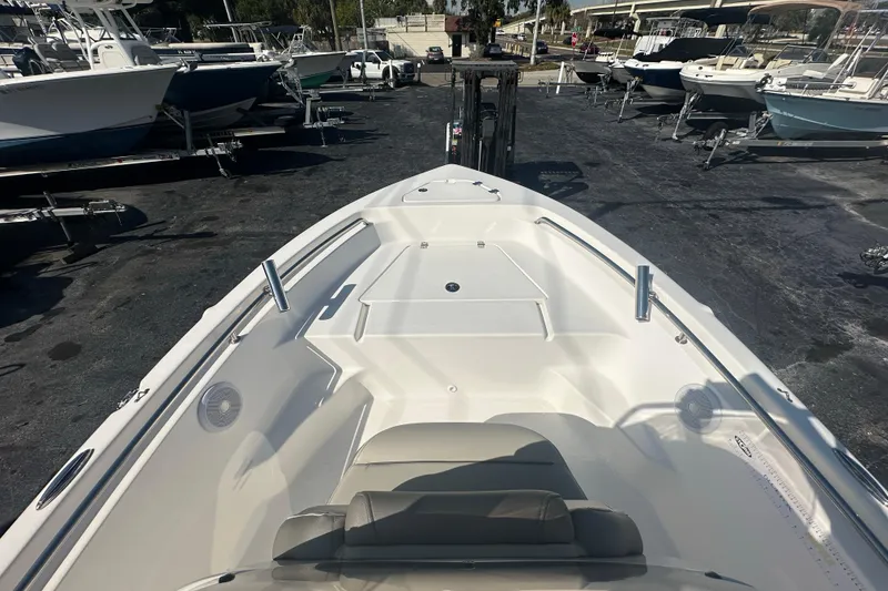 Slide: The Image of 2024 Key West 189 FS boat on display at a marina, showcasing spacious deck design. - 10