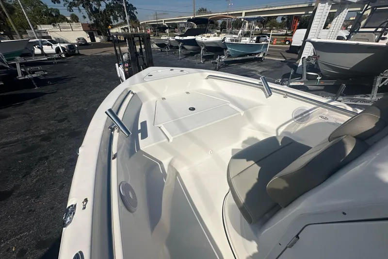 Slide: The Image of 2024 Key West 189 FS boat interior with seating and deck, displayed outdoors. - 11