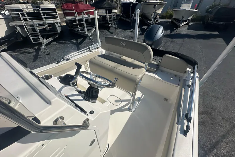 Slide: The Image of 2024 Key West 189 FS boat interior with steering wheel and seating. - 14