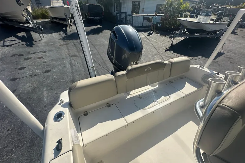 Slide: The Image of 2024 Key West 189 FS boat with outboard motor in a sunny marina. - 22