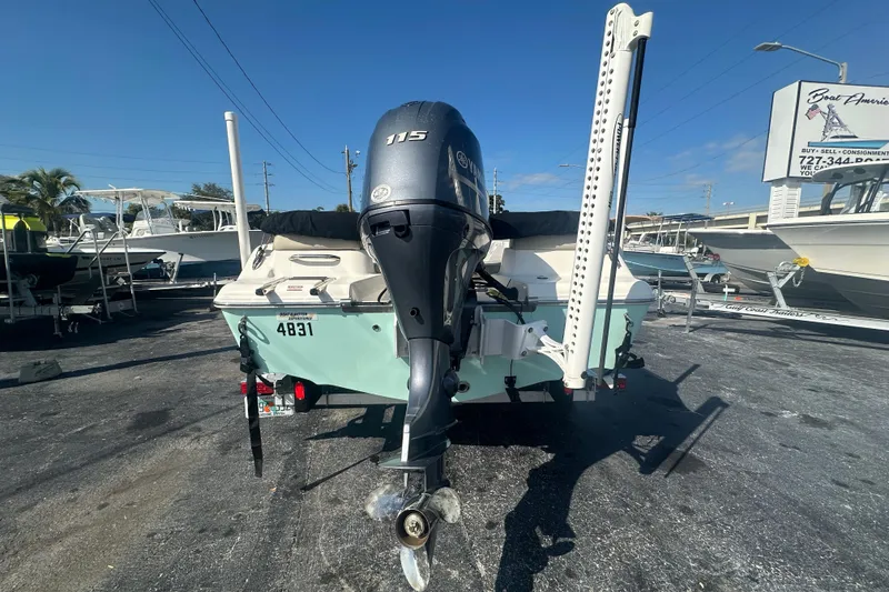 Slide: The Image of 2024 Key West 189 FS boat with Yamaha 115 engine, parked outdoors under clear sky. - 4