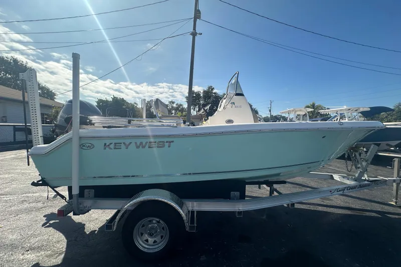 Slide: The Image of 2024 Key West 189 FS boat on trailer under clear blue sky. - 6