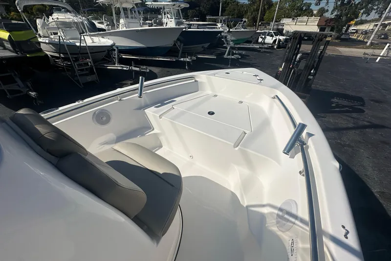 Slide: The Image of 2024 Key West 189 FS boat interior with seating and storage, displayed outdoors. - 9