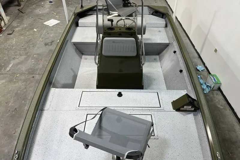 Slide: The Image of 2025 SeaArk Shadow 187J boat interior with seating and steering console. - 10