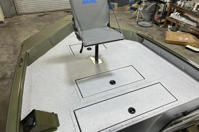 Slide: The Image of 2025 SeaArk Shadow 187J boat interior with swivel chair and storage compartments. - 11