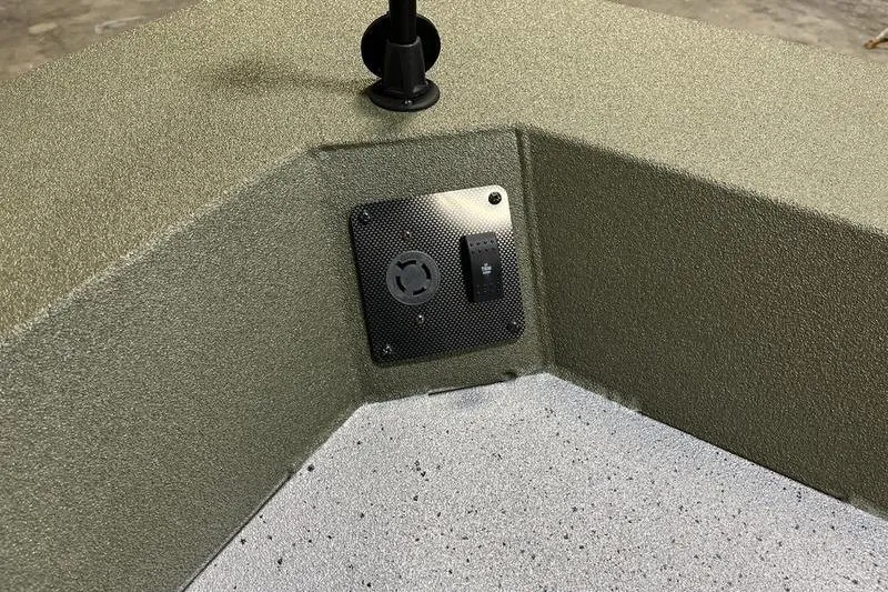 Slide: The Image of Interior detail of 2025 SeaArk Shadow 187J boat, featuring textured surfaces and control panel. - 13