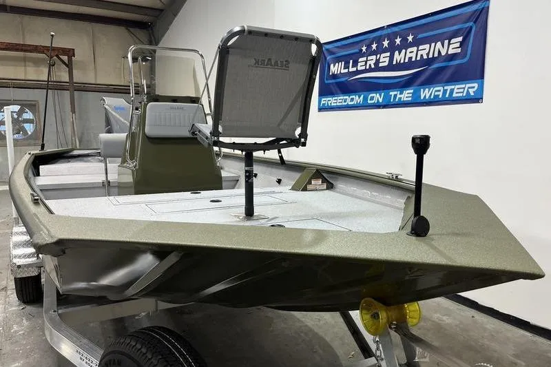 Slide: The Image of 2025 SeaArk Shadow 187J boat in showroom, featuring Miller's Marine banner. - 2