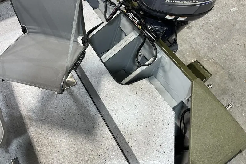 Slide: The Image of 2025 SeaArk Shadow 187J boat interior with seating and motor components. - 5