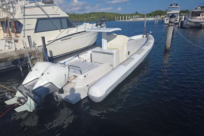 Slide: The Image of Zeta Elle 34 Custom 2013 boat docked in marina with twin outboard motors. - 0
