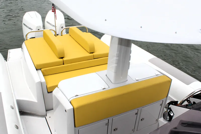 Slide: The Image of 2013 Zeta Elle 34 Custom boat with yellow cushioned seating and dual Mercury outboard motors. - 16
