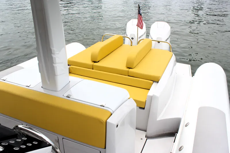 Slide: The Image of 2013 Zeta Elle 34 Custom boat with yellow seating and twin engines. - 17