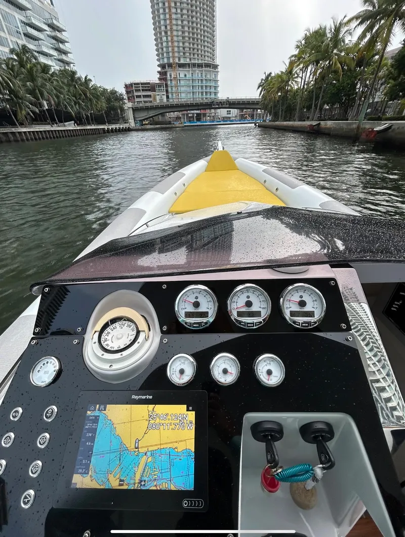 Slide: The Image of Control panel of a 2013 Zeta Elle 34 Custom boat navigating a city canal. - 21