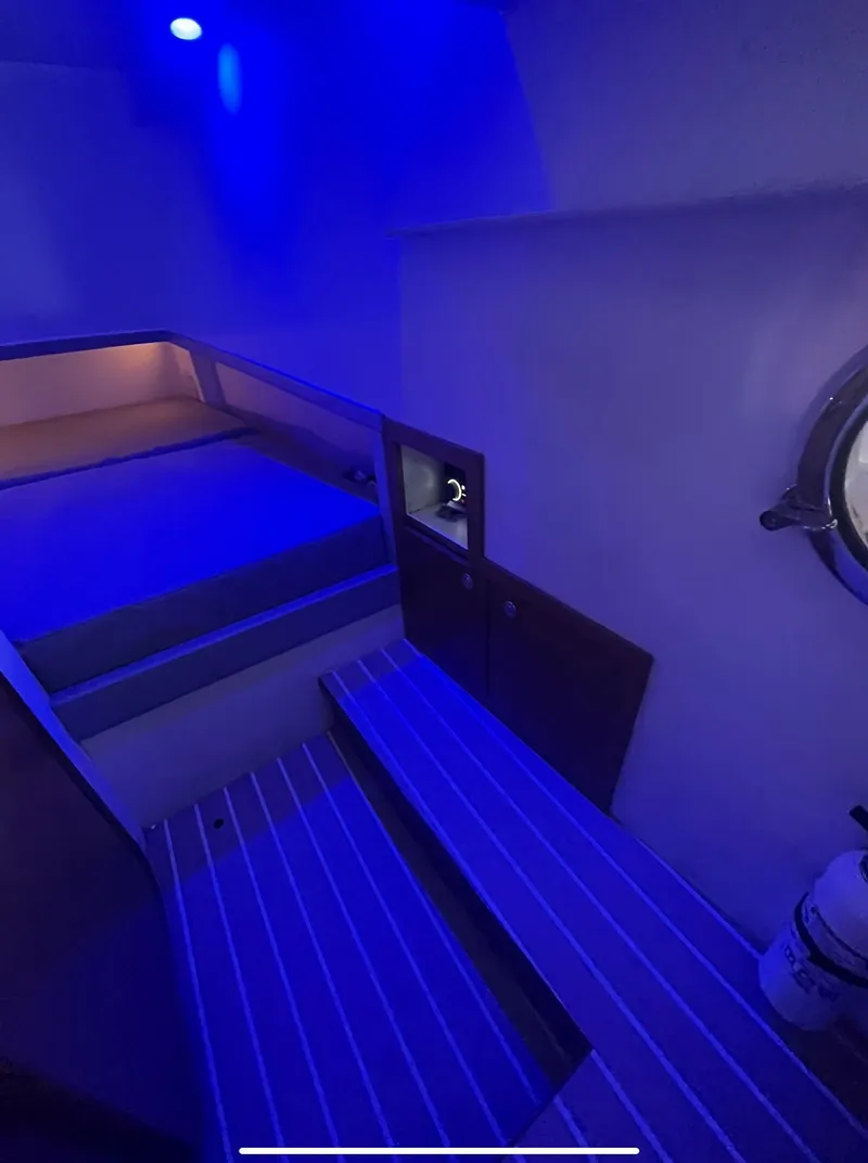 Slide: The Image of Interior cabin of 2013 Zeta Elle 34 Custom yacht with blue ambient lighting. - 22