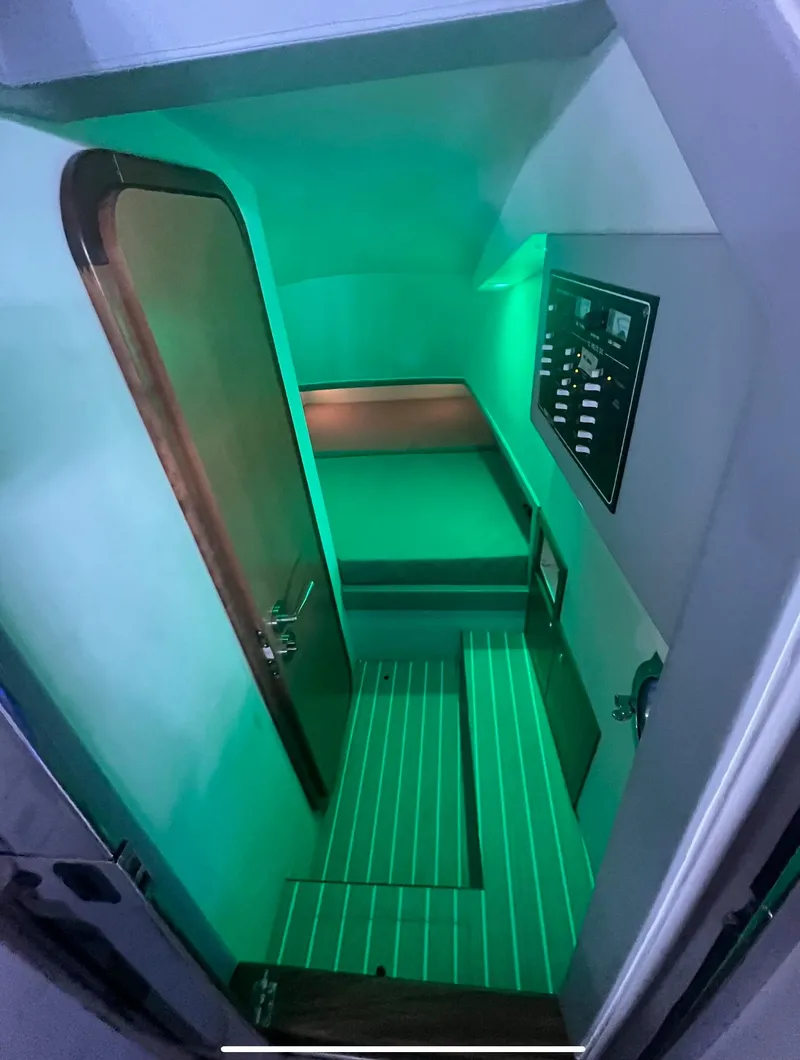 Slide: The Image of Interior cabin of 2013 Zeta Elle 34 Custom boat with green ambient lighting. - 23