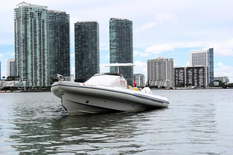 Slide: The Image of Zeta Elle 34 Custom 2013 boat on water with city skyline background. - 7