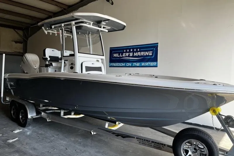 Slide: The Image of 2025 Crevalle 26 HCO boat on trailer at Miller's Marine showroom. - 1