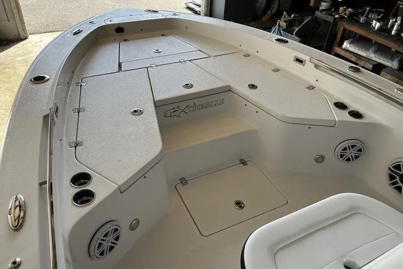 Slide: The Image of 2025 Crevalle 26 HCO boat interior with storage compartments and seating. - 13