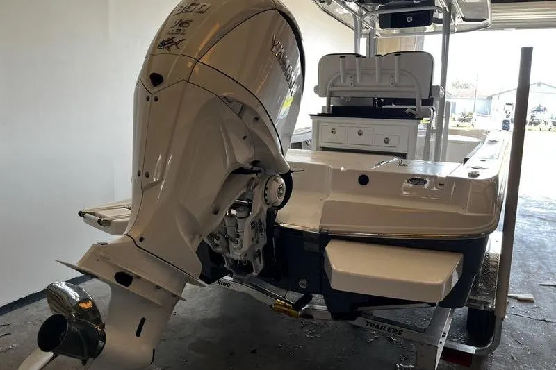 Slide: The Image of 2025 Crevalle 26 HCO boat with powerful outboard motor in a garage setting. - 3