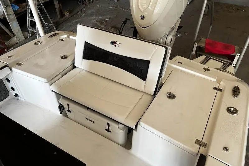 Slide: The Image of 2025 Crevalle 26 HCO boat interior with cushioned seating and storage compartments. - 4