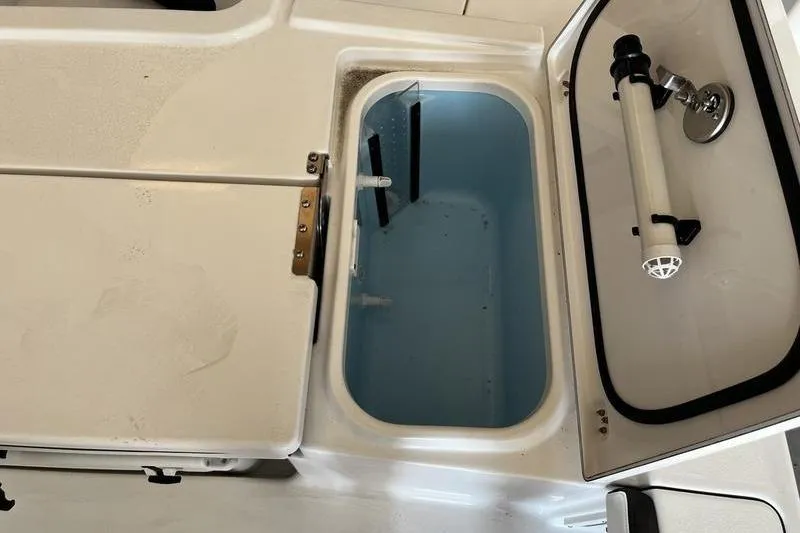Slide: The Image of Open livewell compartment on 2025 Crevalle 26 HCO boat, showcasing interior features. - 5