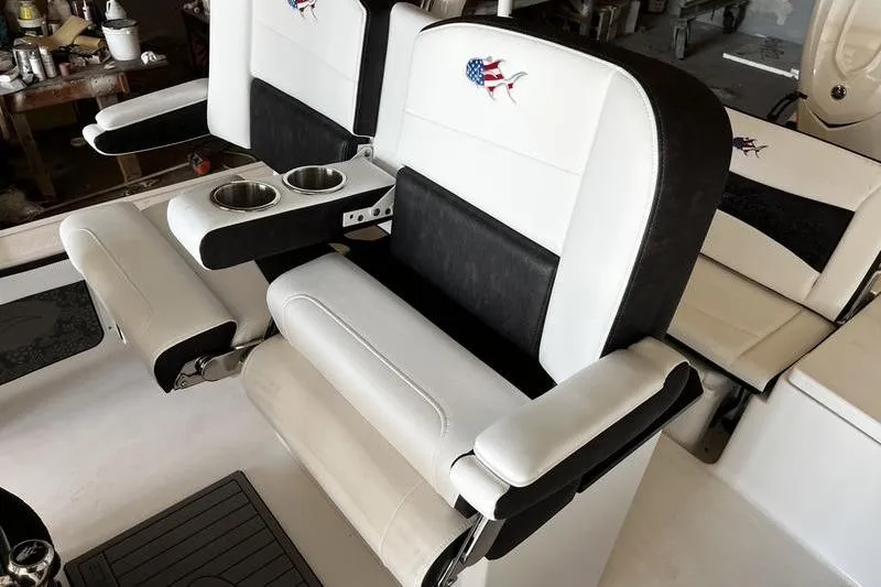 Slide: The Image of 2025 Crevalle 26 HCO boat seats with cup holders and American flag fish logo. - 8
