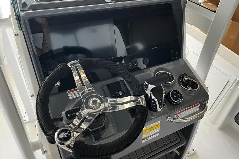 Slide: The Image of 2025 Crevalle 26 HCO boat console with steering wheel and controls. - 9