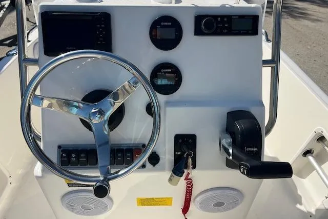 Slide: The Image of 2023 Key West 1720 Center Console boat dashboard with steering wheel and controls. - 9