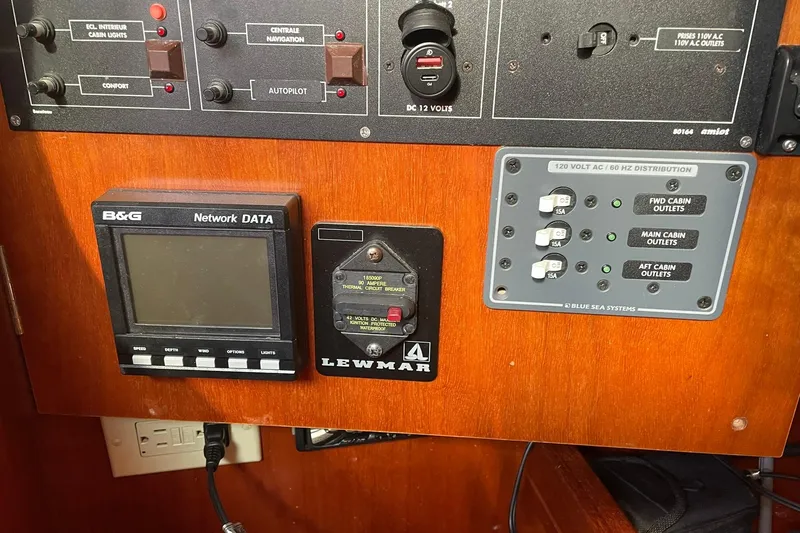 Slide: The Image of Interior of 2001 Beneteau Oceanis 361 sailboat with striped cushions and wooden finishes. - 16