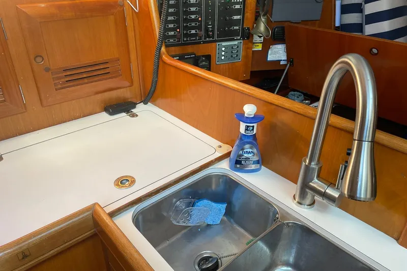 Slide: The Image of Interior cabin of 2001 Beneteau Oceanis 361 with striped cushions and folded canvas. - 19