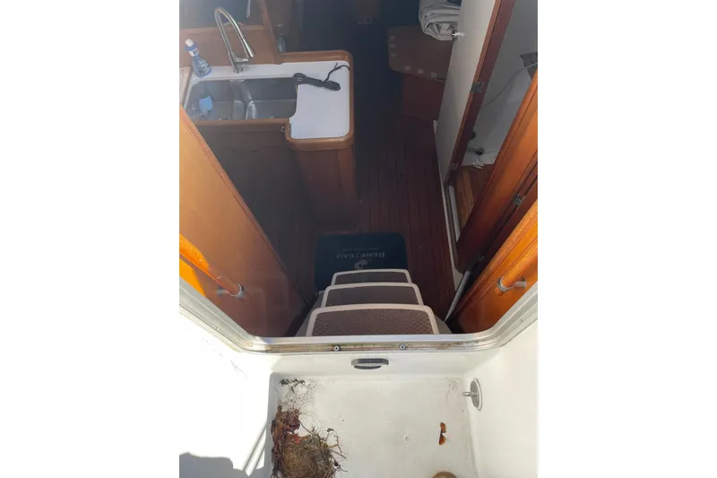 Slide: The Image of Galley sink area in 2001 Beneteau Oceanis 361 sailboat with faucet and cleaning supplies. - 23