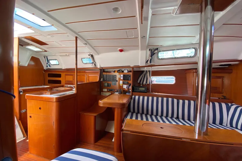 Slide: The Image of Interior of 2001 Beneteau Oceanis 361 sailboat with wood finish and striped seating. - 39
