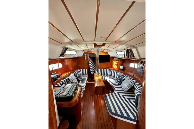 Slide: The Image of Interior of 2001 Beneteau Oceanis 361 sailboat with striped seating and wooden finishes. - 42