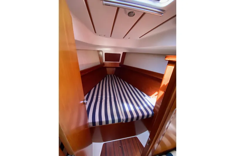 Slide: The Image of Cozy cabin interior of 2001 Beneteau Oceanis 361 with striped bedding. - 43