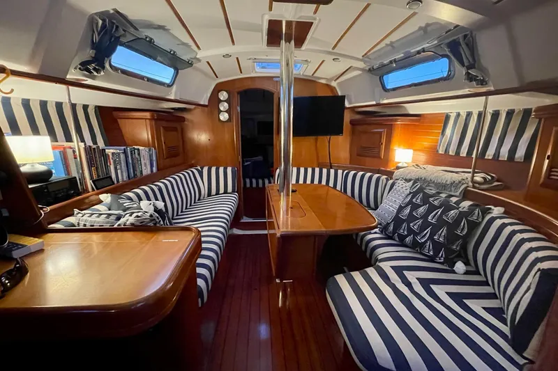 Slide: The Image of Interior of 2001 Beneteau Oceanis 361 sailboat with striped seating and wooden finishes. - 50