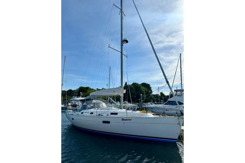 Slide: The Image of 2001 Beneteau Oceanis 361 sailboat docked in a marina under a clear blue sky. - 52