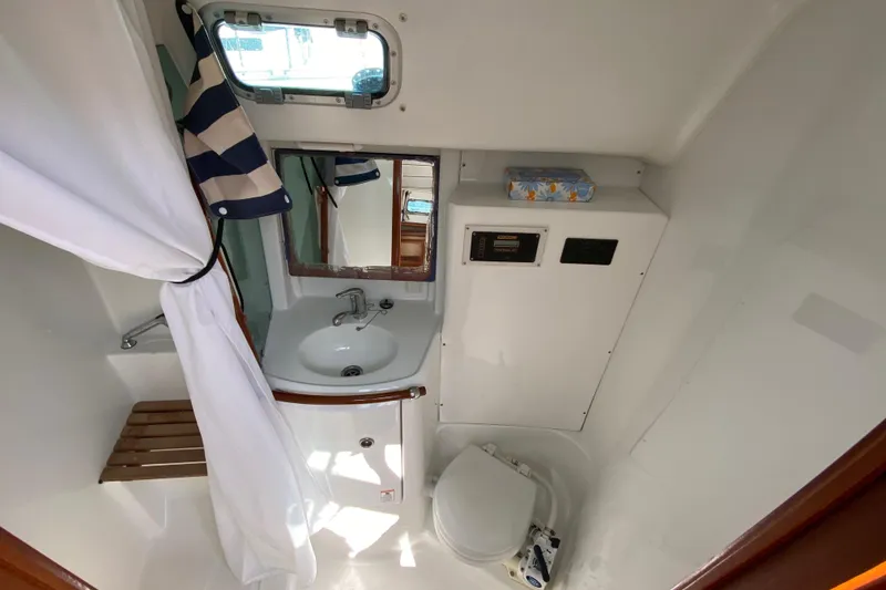 Slide: The Image of Bathroom interior of 2001 Beneteau Oceanis 361 yacht, featuring sink, toilet, and mirror. - 54
