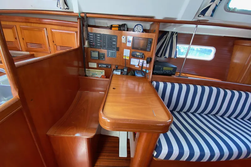 Slide: The Image of 2001 Beneteau Oceanis 361 interior with navigation station and striped seating. - 56