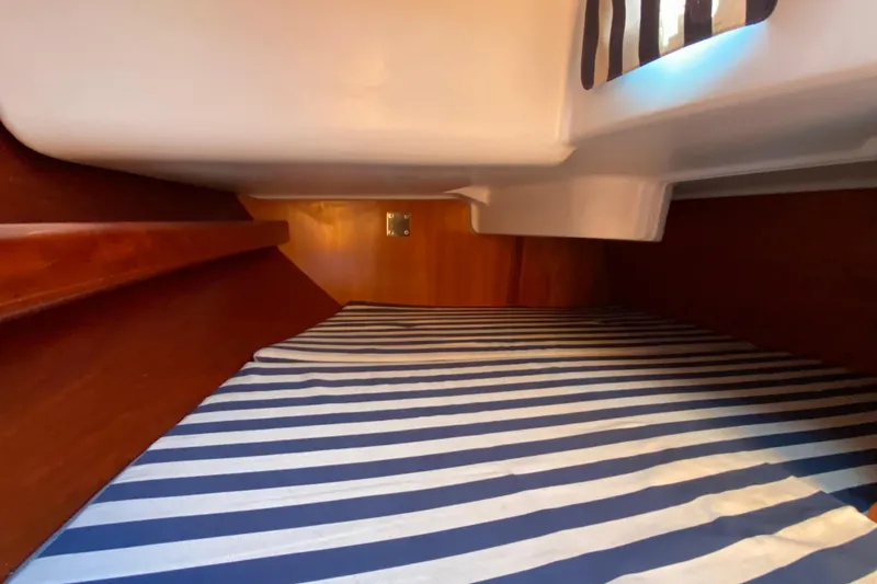 Slide: The Image of Cozy cabin interior of 2001 Beneteau Oceanis 361 with striped bedding. - 60