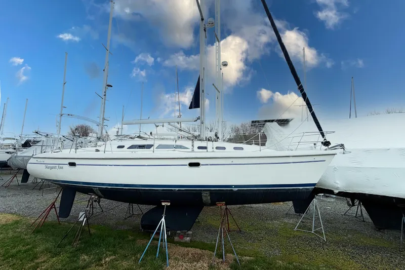 The Image of 2001 Catalina 380 sailboat on stands, under a blue sky with clouds. - 0