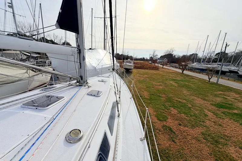 Slide: The Image of Catalina 380 sailboat from 2001 docked in a marina under a bright sky. - 13