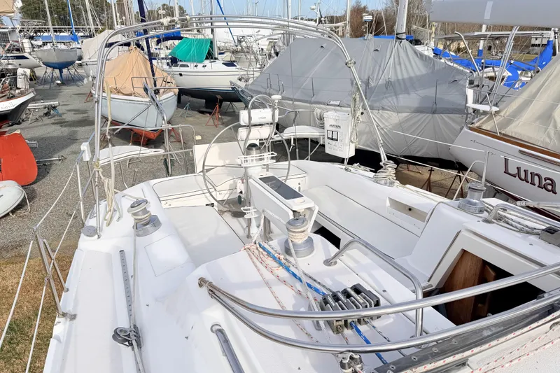 Slide: The Image of 2001 Catalina 380 sailboat cockpit in a marina with other boats. - 14
